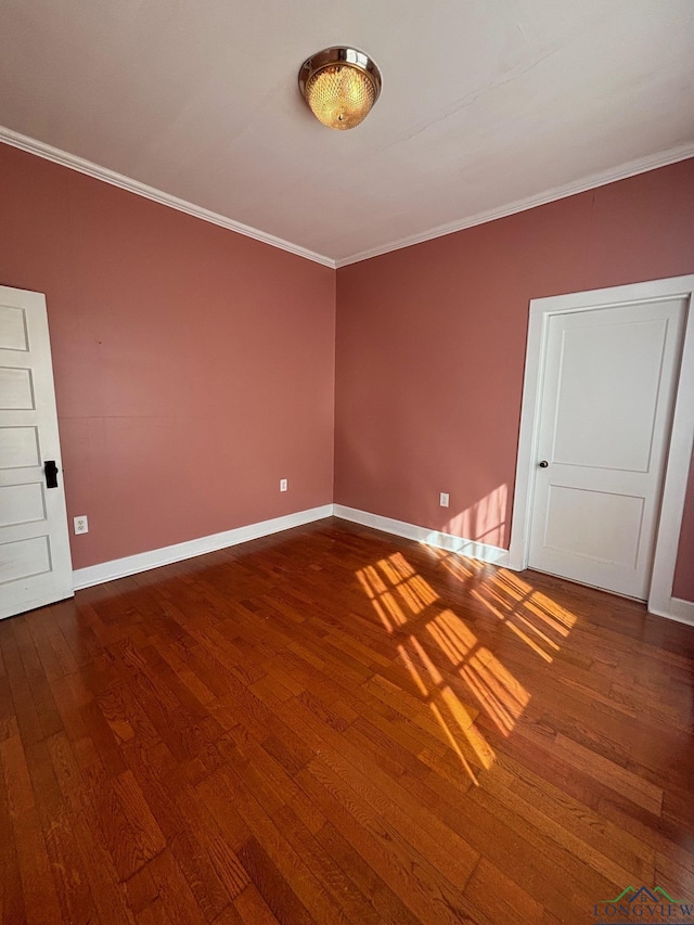 unfurnished room featuring crown molding and hardwood / wood-style flooring