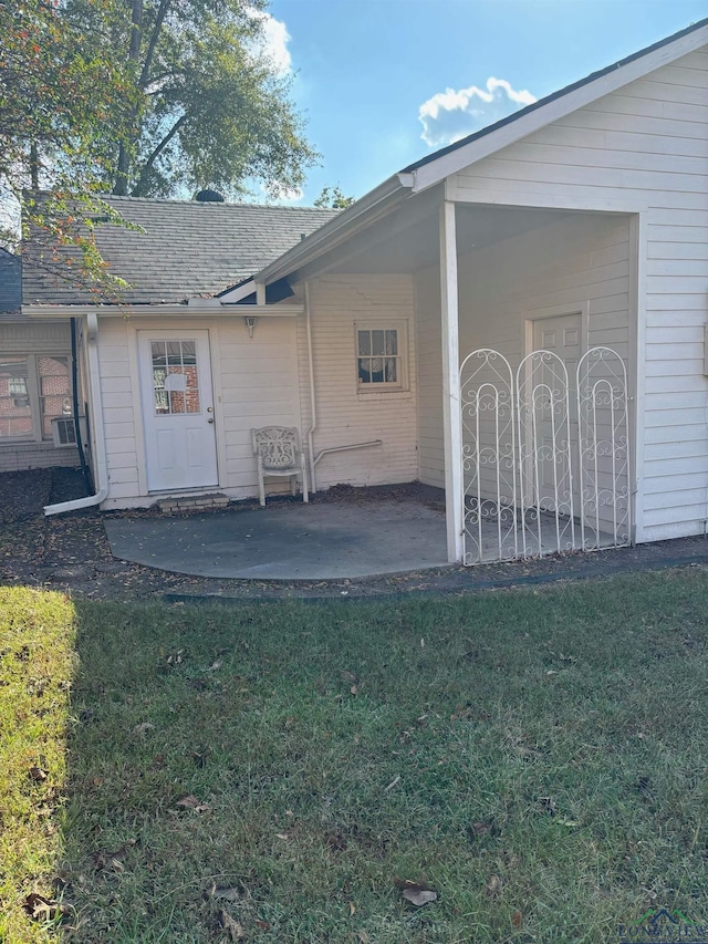 rear view of property featuring a yard and a patio