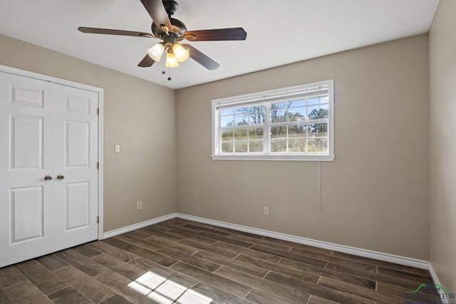 unfurnished bedroom with a closet, ceiling fan, and dark wood-type flooring