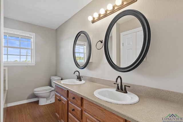 bathroom with vanity, toilet, and wood-type flooring