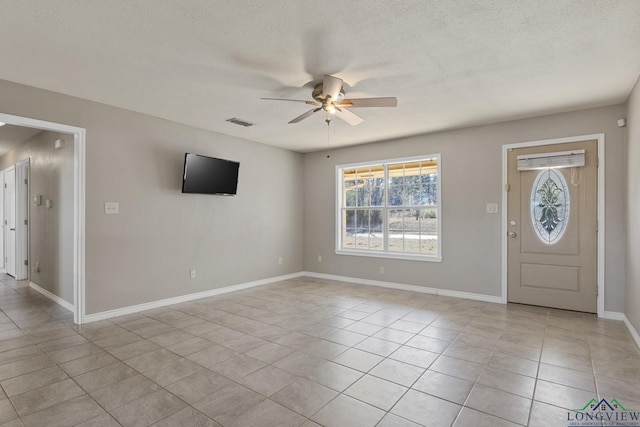 entrance foyer featuring ceiling fan, a textured ceiling, and light tile patterned floors