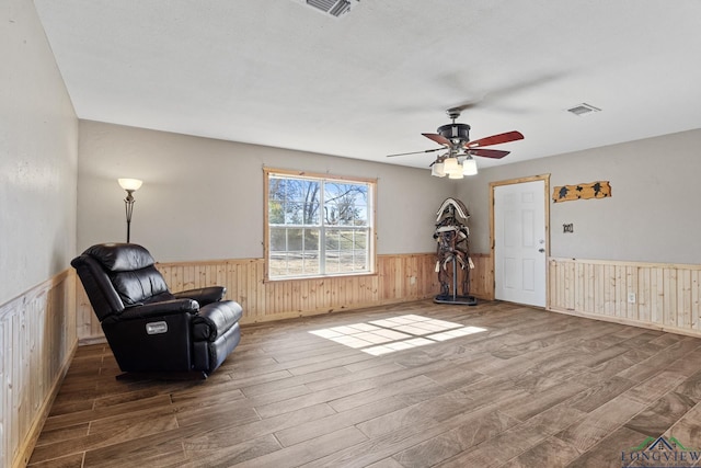 sitting room with hardwood / wood-style flooring and ceiling fan