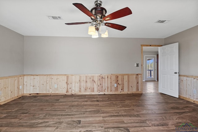 empty room with dark wood-type flooring and ceiling fan