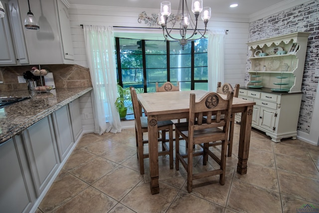 dining room featuring light tile patterned floors, an inviting chandelier, and crown molding