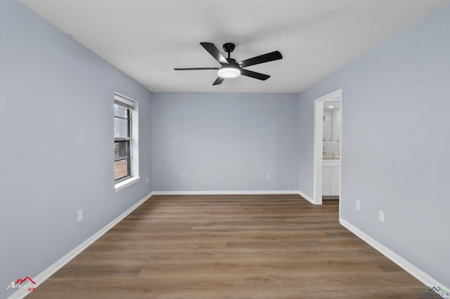 spare room with ceiling fan and wood-type flooring