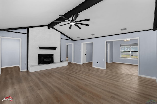 unfurnished living room featuring hardwood / wood-style floors, a fireplace, lofted ceiling with beams, and ceiling fan with notable chandelier