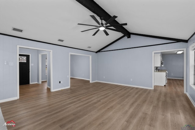 unfurnished living room with vaulted ceiling with beams, light wood-type flooring, and ceiling fan