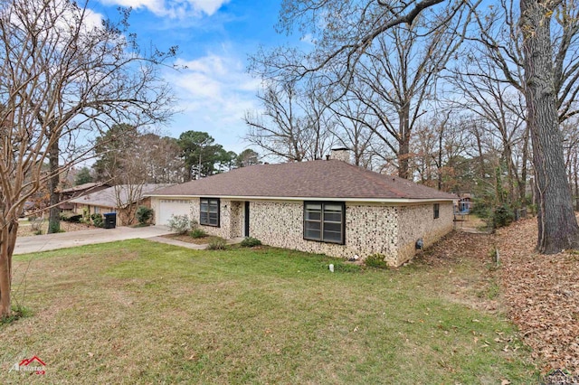 single story home with a front yard and a garage