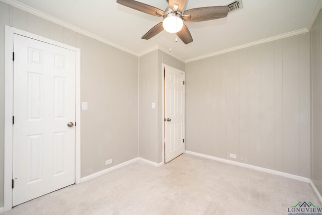 169 Hidden Frst, Longview, TX 75605 - unfurnished bedroom with light colored carpet, baseboards, ornamental molding, and a ceiling fan