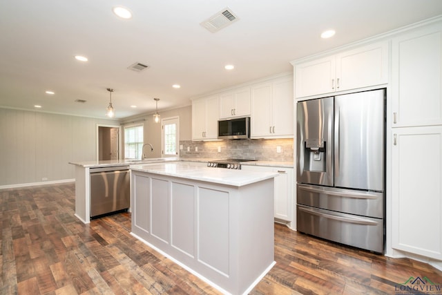 169 Hidden Frst, Longview, TX 75605 - kitchen with appliances with stainless steel finishes, a peninsula, a kitchen island, white cabinetry, and a sink