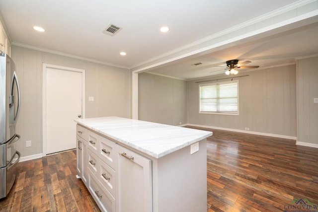 169 Hidden Frst, Longview, TX 75605 - kitchen with stainless steel fridge, light stone countertops, a kitchen island, dark wood finished floors, and ceiling fan