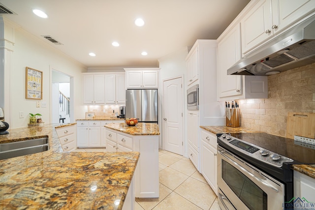 kitchen featuring visible vents, ornamental molding, under cabinet range hood, white cabinetry, and stainless steel appliances