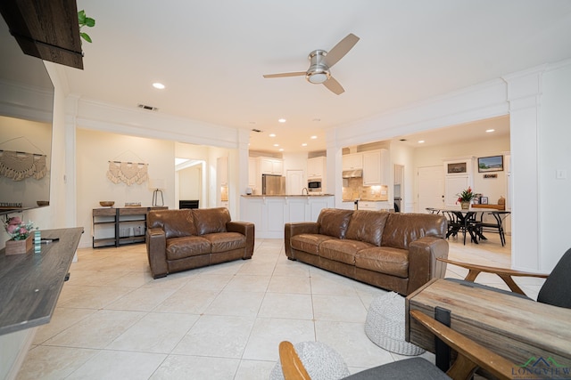 living room with light tile patterned floors, recessed lighting, visible vents, and ceiling fan