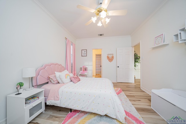 bedroom with crown molding, light wood-style floors, visible vents, and baseboards