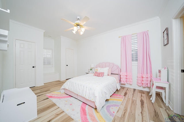 bedroom featuring baseboards, multiple windows, light wood-style floors, and ornamental molding