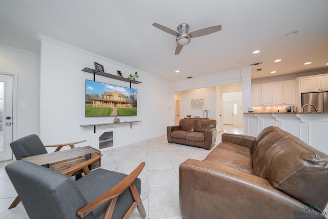 living room featuring light tile patterned floors, a ceiling fan, baseboards, recessed lighting, and crown molding