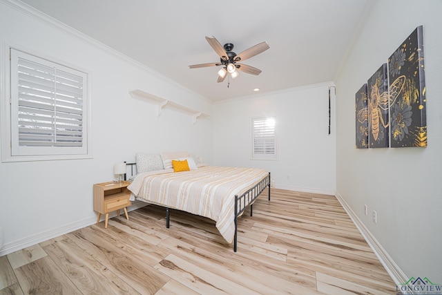 bedroom with light wood-type flooring, baseboards, ceiling fan, and crown molding