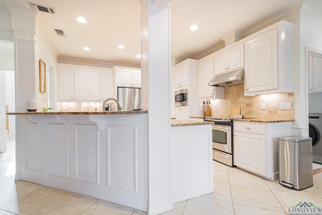 kitchen featuring light stone countertops, visible vents, white cabinets, appliances with stainless steel finishes, and under cabinet range hood