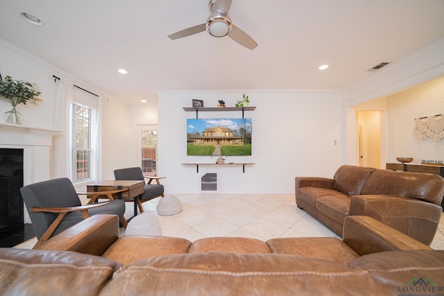 living room with recessed lighting, visible vents, and crown molding