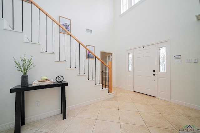 entryway with tile patterned floors, visible vents, and stairs