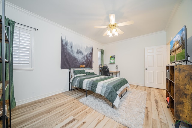 bedroom featuring ceiling fan, wood finished floors, baseboards, and ornamental molding