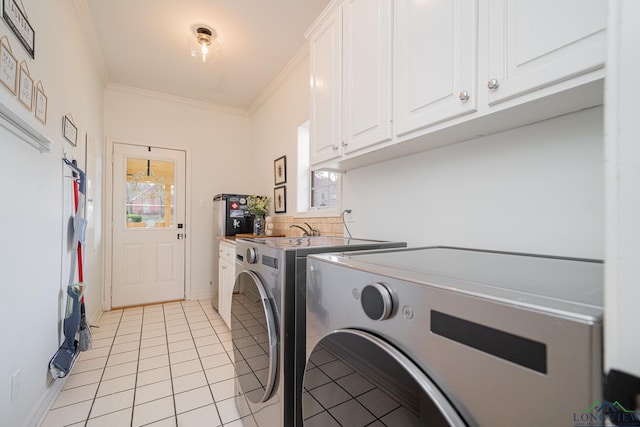 laundry area with cabinet space, independent washer and dryer, a wealth of natural light, and ornamental molding