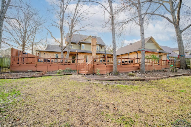 view of yard featuring a wooden deck and fence