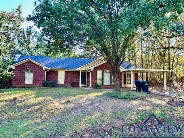 single story home featuring a carport and a front yard