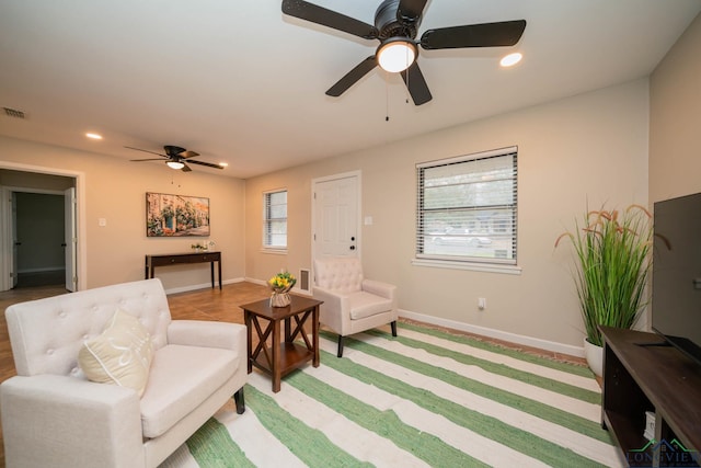 living area with ceiling fan