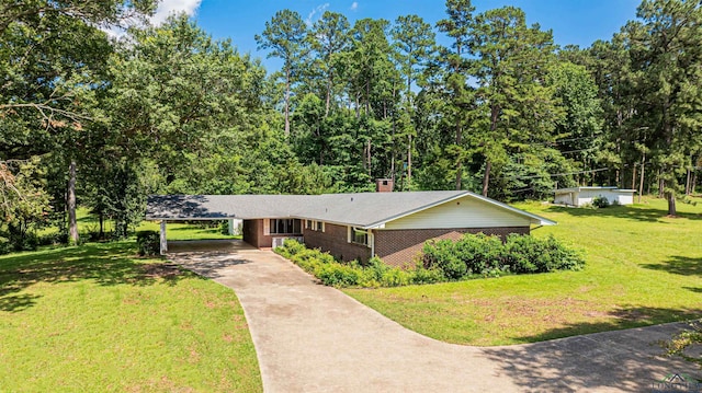 201 Bronco Ln, Linden, TX 75563 - view of front of house featuring concrete driveway, brick siding, a front lawn, and a chimney