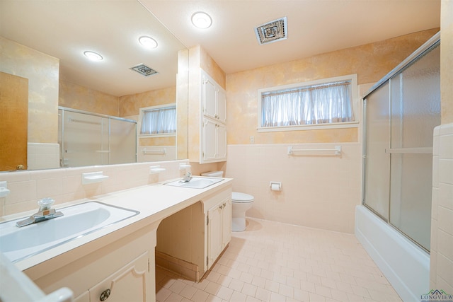 201 Bronco Ln, Linden, TX 75563 - bathroom featuring tile walls, double vanity, tile patterned floors, and enclosed tub / shower combo