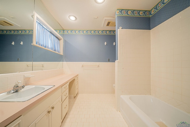 201 Bronco Ln, Linden, TX 75563 - full bathroom featuring vanity, wallpapered walls, tile walls, tile patterned floors, and wainscoting