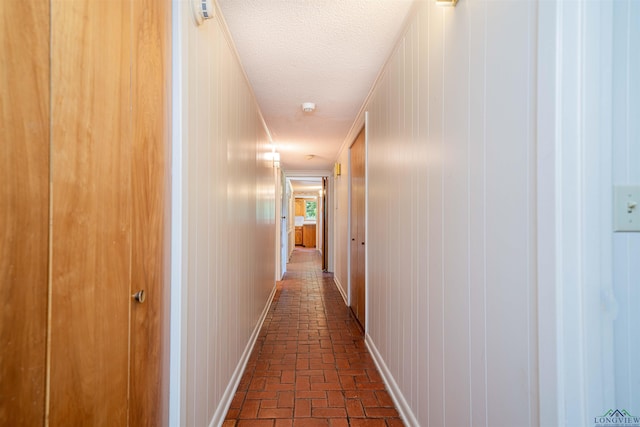 201 Bronco Ln, Linden, TX 75563 - hall featuring brick flooring and a textured ceiling