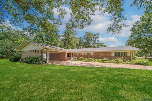 201 Bronco Ln, Linden, TX 75563 - ranch-style home featuring a front lawn, a carport, driveway, brick siding, and a chimney