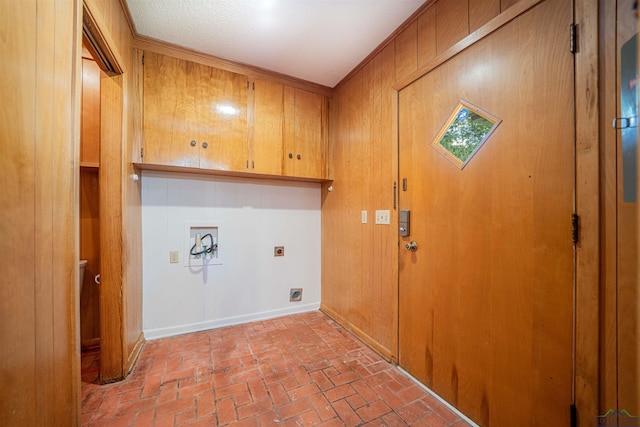 201 Bronco Ln, Linden, TX 75563 - laundry room with cabinet space, electric dryer hookup, wood walls, hookup for a washing machine, and brick floors