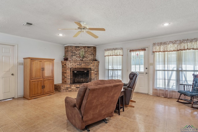 2574 County Road 3412, Chandler, TX 75758 - living room with ceiling fan, a textured ceiling, crown molding, a brick fireplace, and recessed lighting