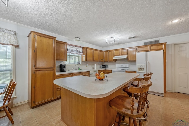 2574 County Road 3412, Chandler, TX 75758 - kitchen with white appliances, a sink, under cabinet range hood, light countertops, and a textured ceiling