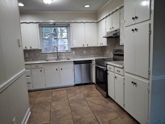 kitchen with a textured ceiling, stainless steel appliances, sink, dark tile patterned flooring, and white cabinetry