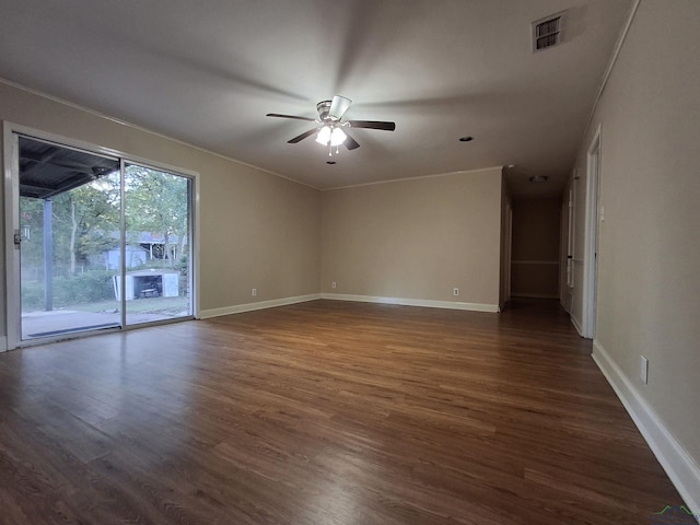 spare room featuring ceiling fan, ornamental molding, and dark wood-type flooring