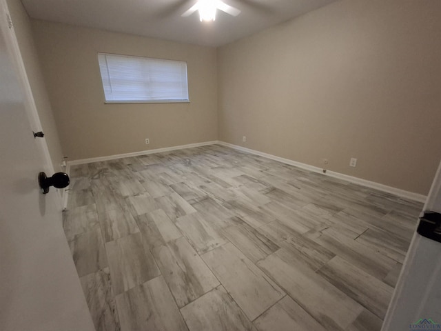 empty room with light wood-type flooring and ceiling fan