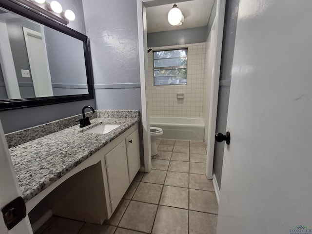 full bathroom featuring tile patterned flooring, vanity, tiled shower / bath combo, and toilet