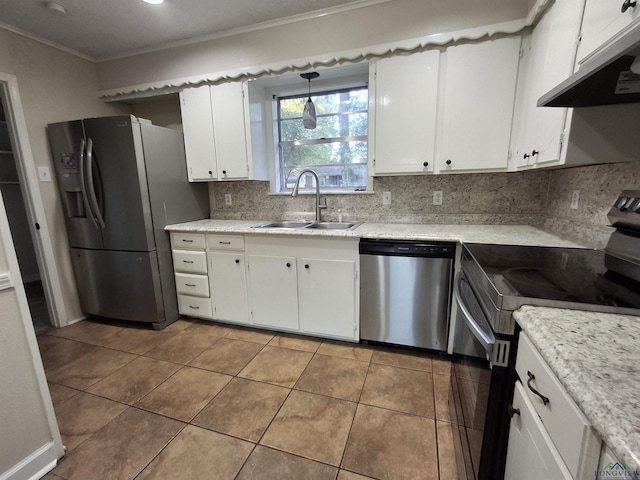 kitchen featuring white cabinets, sink, light tile patterned floors, appliances with stainless steel finishes, and decorative light fixtures