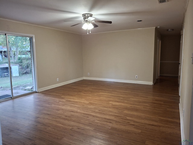 spare room with ceiling fan, dark wood-type flooring, and ornamental molding