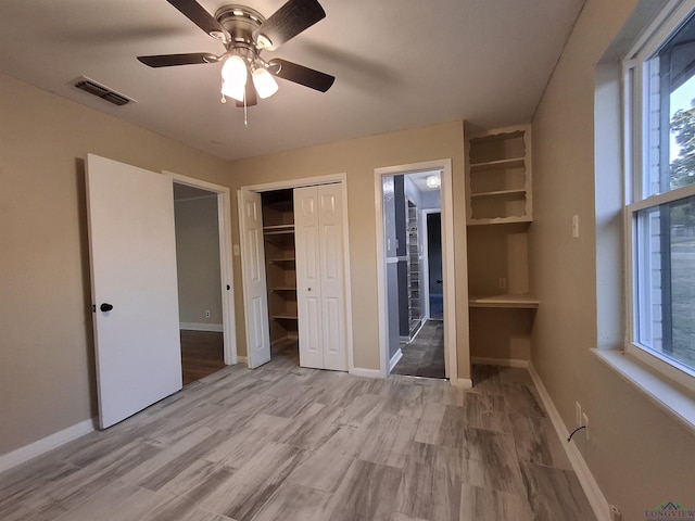 unfurnished bedroom with ceiling fan, light hardwood / wood-style floors, and connected bathroom