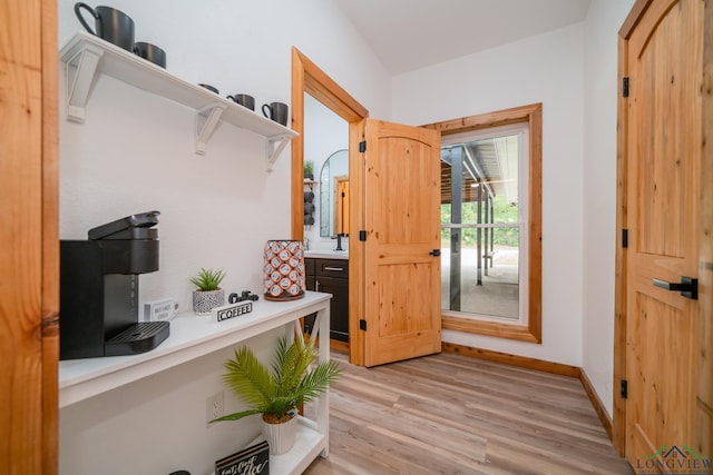 doorway featuring sink and light wood-type flooring