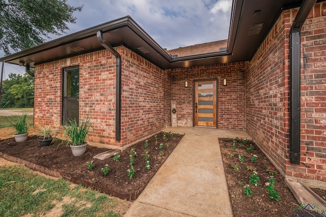 view of exterior entry featuring a patio