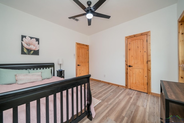 bedroom featuring light hardwood / wood-style flooring and ceiling fan