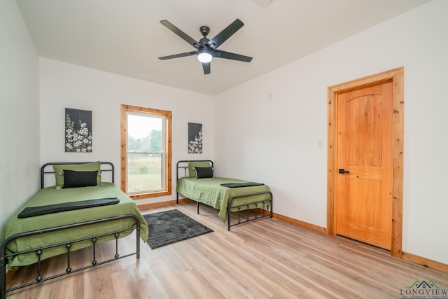 bedroom with ceiling fan and light wood-type flooring