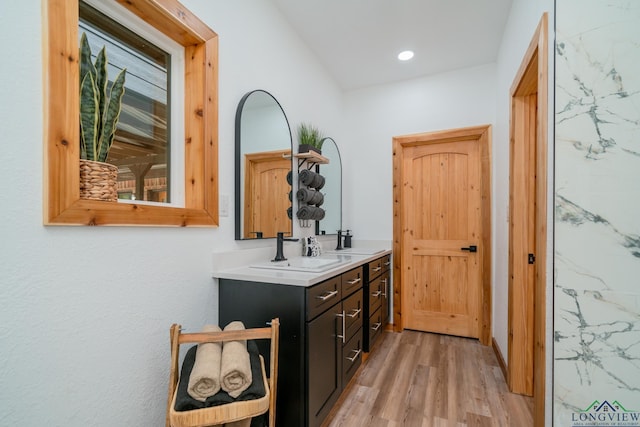 hall featuring sink and light hardwood / wood-style flooring