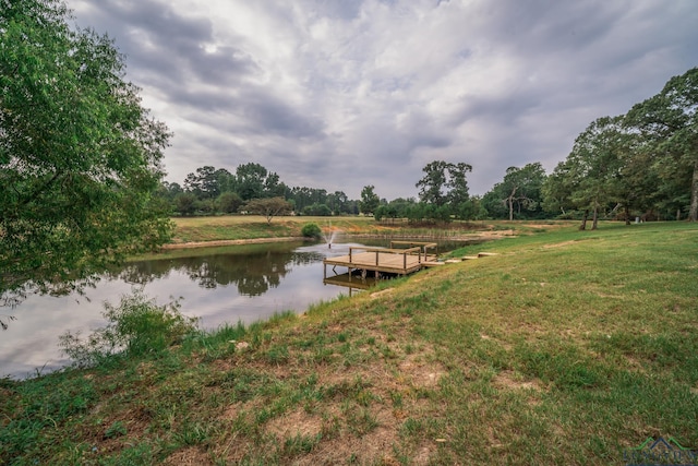 dock area featuring a water view and a yard